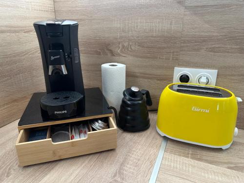a coffee maker and a toaster on a table at LeLafayette in Metz