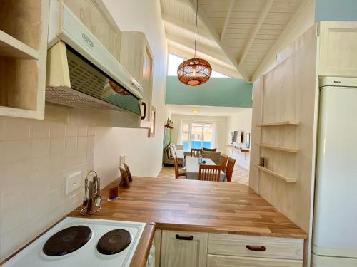 a kitchen with a wooden counter top and a refrigerator at Sealavie Central Apartment in Khomas Region