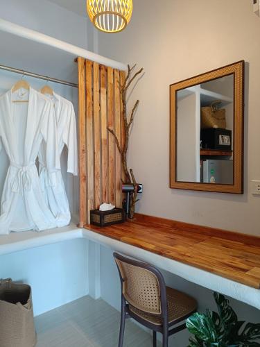 a dressing room with a mirror and a chair at Marine House Koh Tao in Ko Tao
