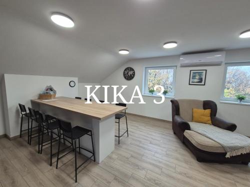 a living room with a table and chairs and a couch at Kika apartmani-FREE PARKING- 7 km od centra in Zagreb