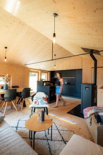 a man walking through a living room of a house at ALTYPIC Mayen d'exception en Valais in Bruson
