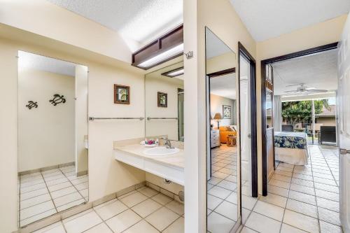 a bathroom with a sink and a mirror at Eldorado D106 · EL D106 Relaxing Kaanapali Condo w Pool AC Beach in Kahana