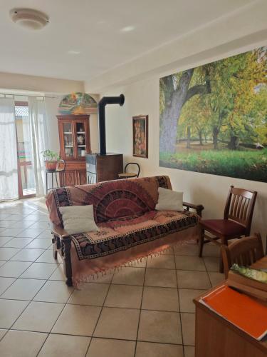 a living room with a couch and a painting on the wall at Bed&Breakfast Castagna in Carlopoli