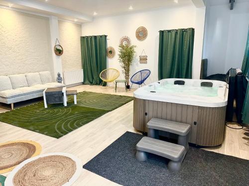 a living room with a jacuzzi tub and green curtains at Hotel Particulier Les Rêveries du CLOS derrière St Jean Vignes &Spa Adult Only in Pommard