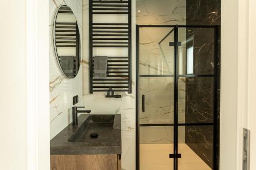 een badkamer met een wastafel en een spiegel bij Hillenaar in Huppel