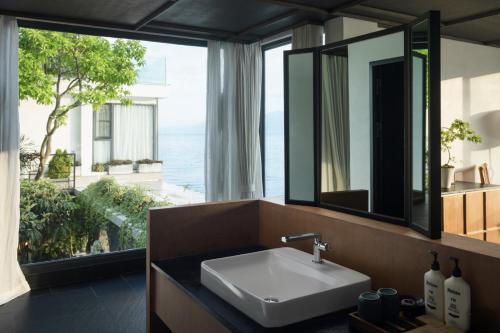 a bathroom with a sink and a large window at Dali Lanting Seaview Hotel in Dali