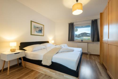 a bedroom with a large bed and a window at Ferienhaus Gehrenblick in Oberletzen