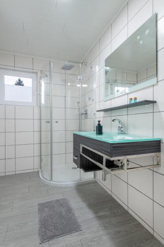 a bathroom with a sink and a shower at Ferienhaus Gehrenblick in Oberletzen
