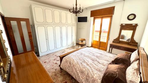 a bedroom with a bed and a table and a clock at B&E Casa Vacanze in Taranto
