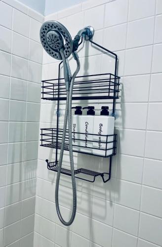 a shower head hanging on a wall in a bathroom at Cozy house 15 mins to Fort Benning in Central Columbus in Columbus