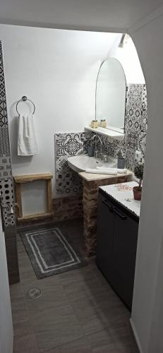 a bathroom with a sink and a mirror at Eleonoras House in Leonidio