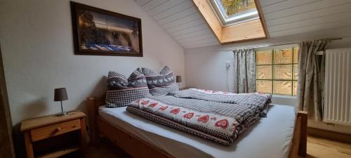 a bedroom with a bed and a window at Time Out Moments Haus mit eigener Sauna in Grafenau