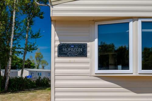 a sign on the side of a building with a window at 3 Bed Caravan - Seton Sands in Port Seton