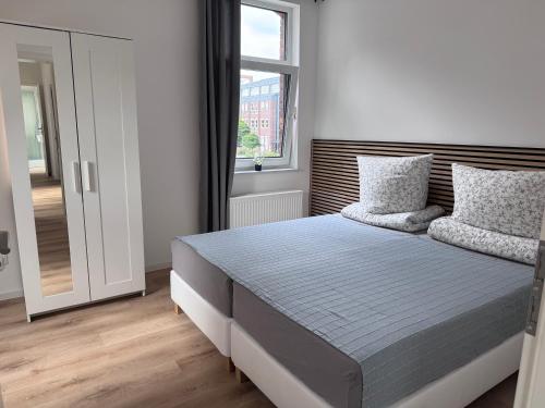 a bedroom with a large bed with a window at Bothfeld Suite in Hannover