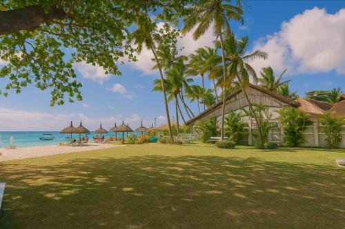 a resort on the beach with palm trees and the ocean at Serge's Beachfront by Serenity in Trou aux Biches