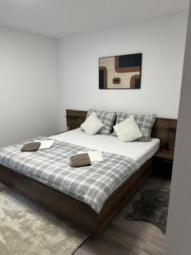 a bedroom with a bed with two towels on it at Lux Stay Apartmant in Varaždin