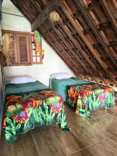 two beds sitting next to each other in a room at Gravata Paradise in Gravatá