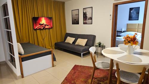 een woonkamer met een bank en een tafel bij Turecka 49 Apt 2 in Nové Zámky