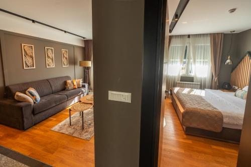 a living room with a bed and a couch at Modern Mountain - Comfort Apartment in Kolašin