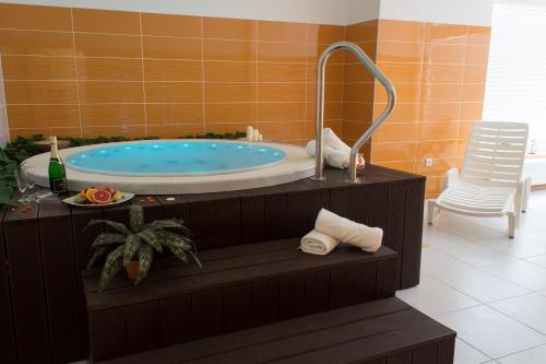 a bathroom with a jacuzzi tub in a room at Hotel Harmonie in Luhačovice