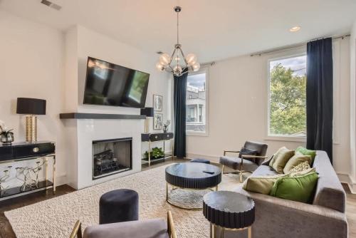 a living room with a couch and a tv at Luxury Condo - The Gulch - Private Rooftop in Nashville