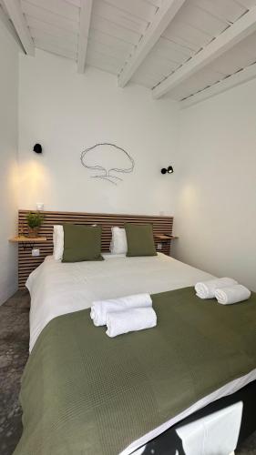 a bedroom with a large bed with towels on it at Casa das Andorinhas-Alentejo in Vidigueira