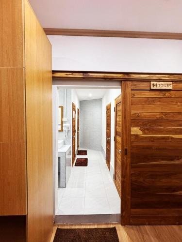 a hallway with a door leading to a bathroom at Demi Cafe and Hostel in Vientiane
