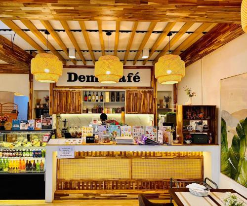 a restaurant with a drink counter in a store at Demi Cafe and Hostel in Vientiane