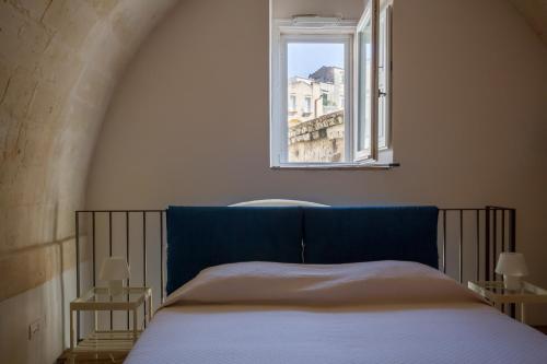 Ένα ή περισσότερα κρεβάτια σε δωμάτιο στο Casamata Matera