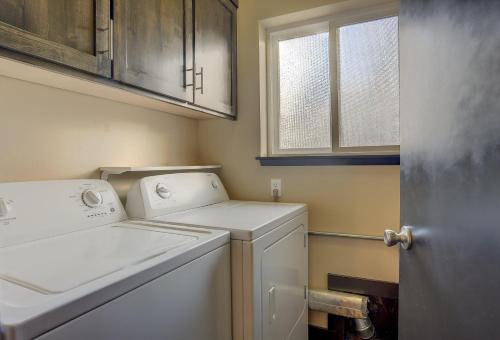 a laundry room with a washer and dryer at Urban Roundabout in Bend