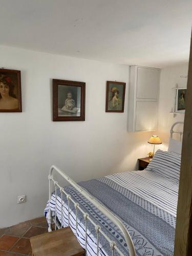 a bedroom with a bed and two pictures on the wall at Chambre privée autonome in Ouilly-du-Houley