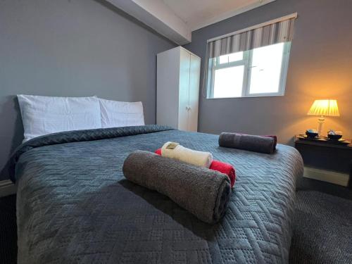 a bedroom with a bed with two stuffed animals on it at Osterley Park Hotel in Syon Lane Station