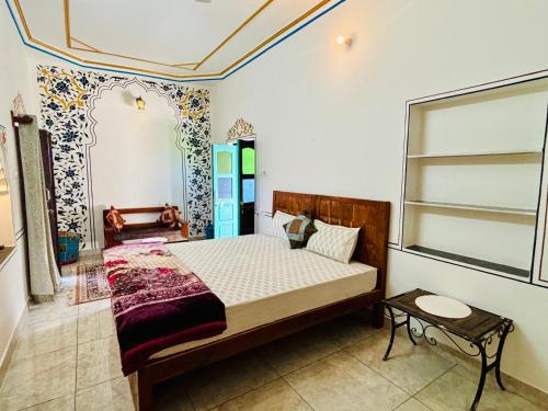 a bedroom with a bed in a room with a window at Hotel tulsi palace in Pushkar