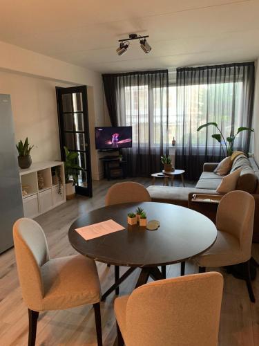 a living room with a table and chairs at The Scheveningse Meisjes in Scheveningen