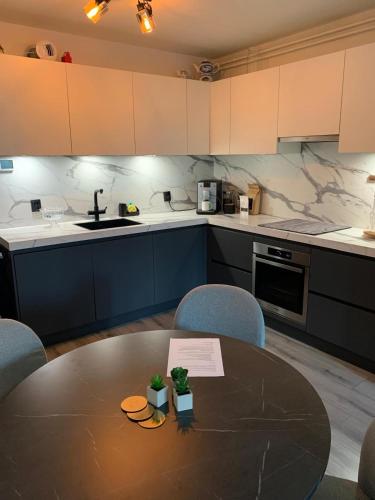 a kitchen with a table and chairs and a kitchen with a sink at The Scheveningse Meisjes in Scheveningen