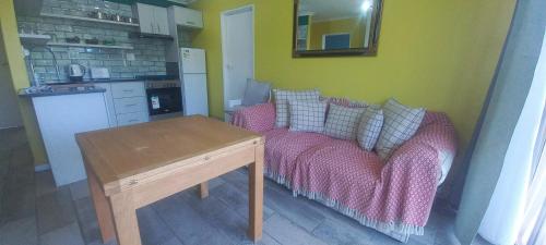a living room with a couch and a table at Unit 8 Hermanus Beach Club in Hermanus