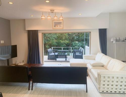 a living room with a white couch and a table at ISU BASE - Vacation STAY 12851 in Shima
