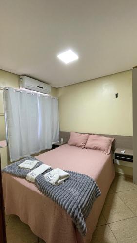 a bedroom with a bed with two towels on it at Apto 013 - Residencial Canaã in Porto Velho