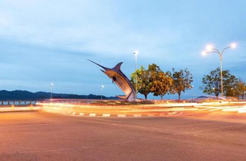 a statue of a shark in a parking lot at The Shore in Kota Kinabalu