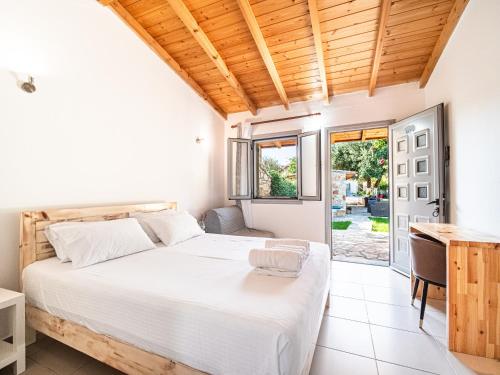 a bedroom with a bed and a desk at Janakis Garden Livadi Beach in Spile