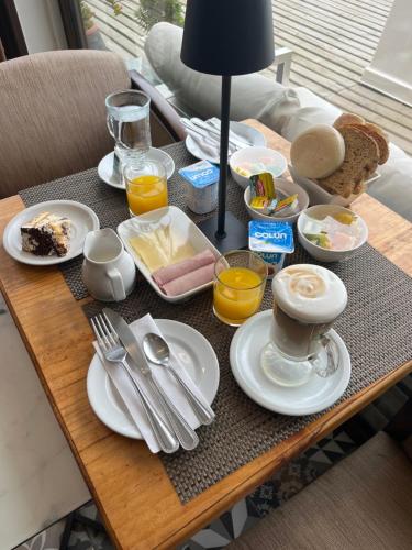 a table with breakfast food on top of it at Laura del Mar Hotel Boutique in Concón