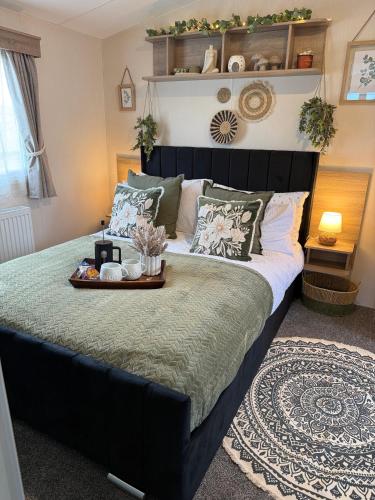a bedroom with a large bed with a tray on it at Luxury Caravan, On the beach in Redcar
