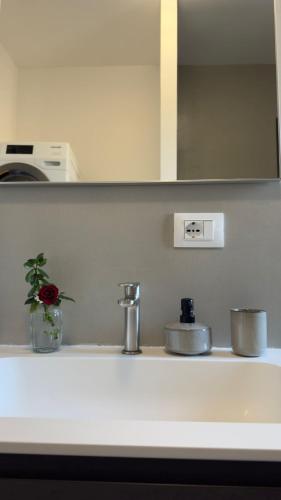 a kitchen counter with a sink and a mirror at Alla Torre - Room & Private Bathroom in Treviso