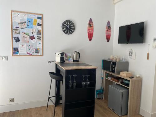a kitchen with a counter and a sink on a wall at Sur la route des châteaux in Soussans