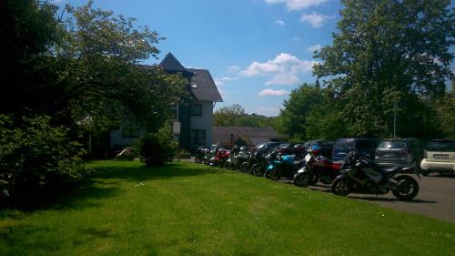 a line of motorcycles parked in front of a house at Landhotel Karrenberg in Kirchberg