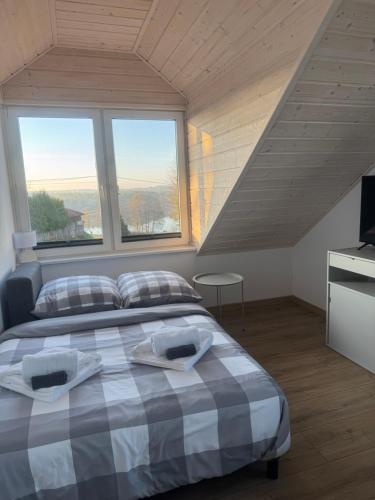 a bedroom with a bed with two towels on it at Przystanek Niesiołowice - na Kaszubach in Niesiołowice