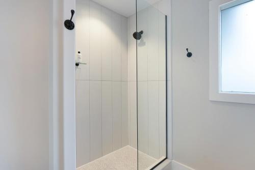 a shower with a glass door in a bathroom at Harmony House in Nashville