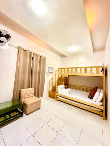 a bedroom with two bunk beds and a desk at Shing Spa Resort in Brooke's Point
