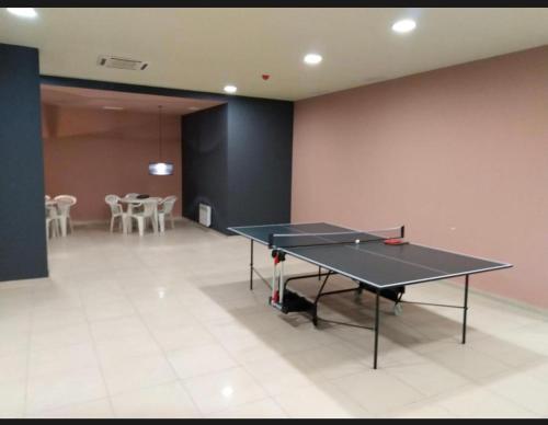 a ping pong table in the middle of a room at Aspen Luxury Apartamnet in Razlog