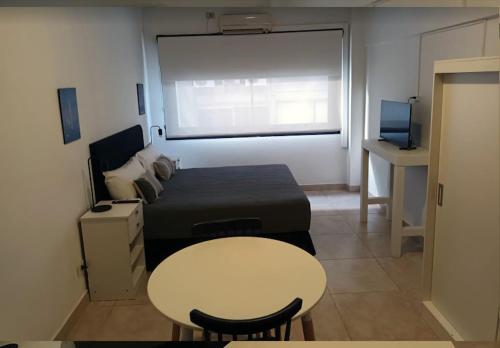 a small room with a table and a bed and a table and a small table at Appart Tucuman in Buenos Aires
